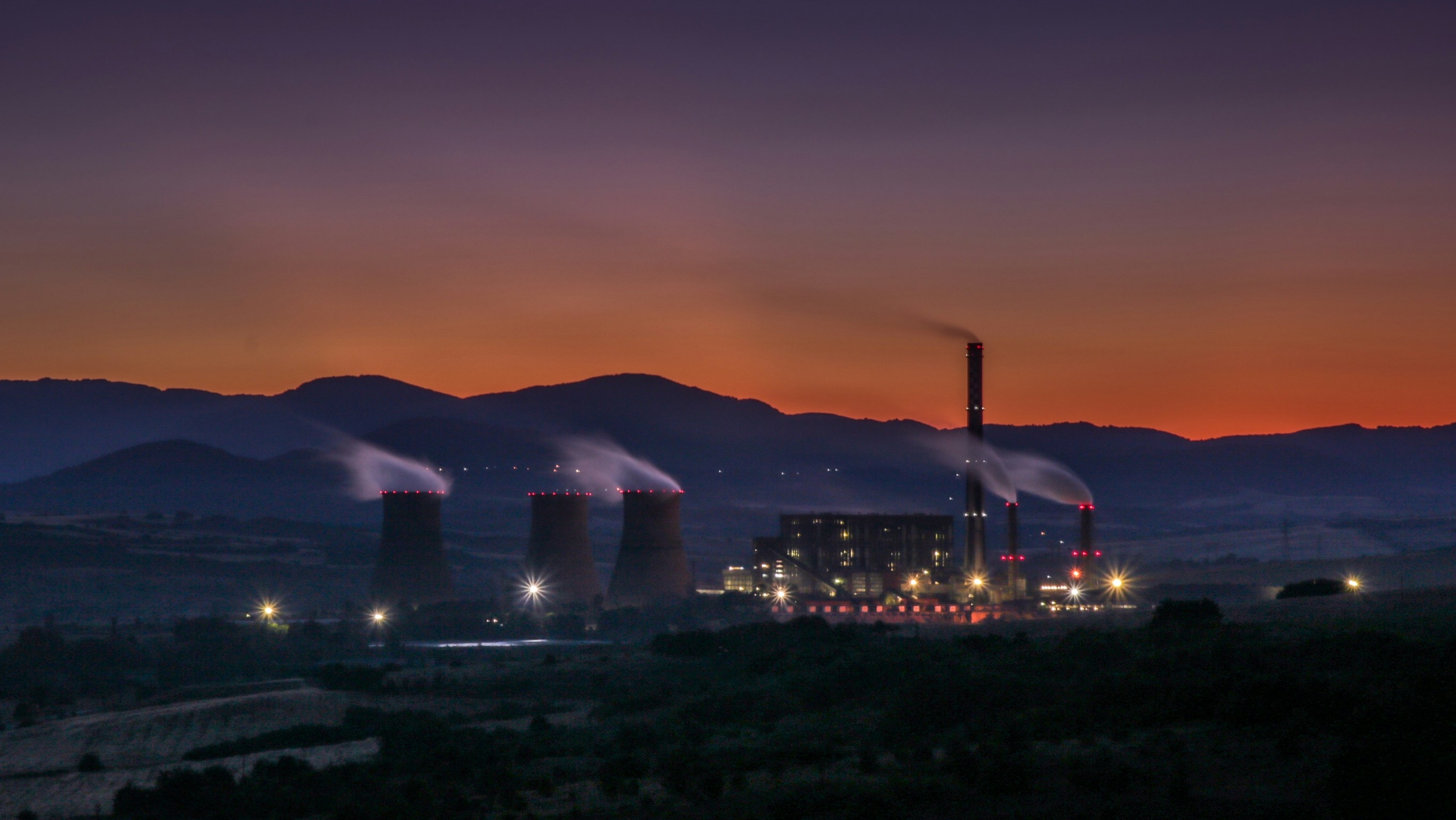 Industrial power plant at sunset