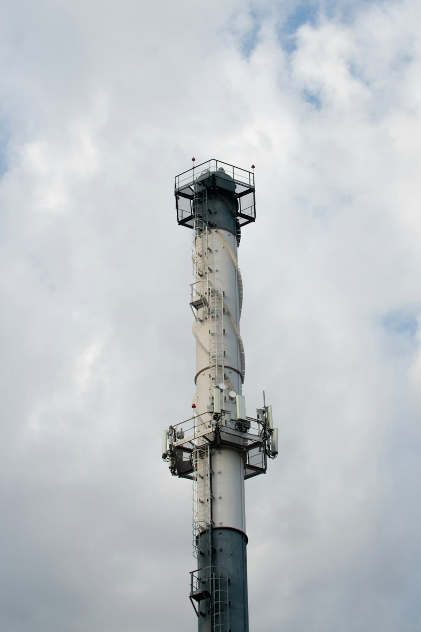 Industrial plant smoke stack against a cloudy sky